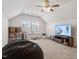 Spacious bonus room with a TV, a beanbag chair, and plenty of room for activities at 356 Avery Glenn Way, Fuquay Varina, NC 27526