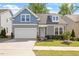 Charming two-story home featuring a two-car garage, manicured lawn, and tasteful landscaping at 356 Avery Glenn Way, Fuquay Varina, NC 27526