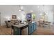 Stylish kitchen boasts an island with barstool seating that adjoins a living area with fireplace at 356 Avery Glenn Way, Fuquay Varina, NC 27526