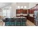 Bright open kitchen with dark cabinets, island seating and modern stainless steel appliances at 356 Avery Glenn Way, Fuquay Varina, NC 27526