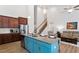 Open-concept kitchen with stainless appliances, island seating, and hardwood floors flowing to living area at 356 Avery Glenn Way, Fuquay Varina, NC 27526