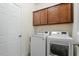 Laundry room featuring a washer, dryer, and upper cabinets for storage at 356 Avery Glenn Way, Fuquay Varina, NC 27526