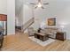Open concept with hardwood floors, stairs, comfortable seating, and modern decor at 356 Avery Glenn Way, Fuquay Varina, NC 27526