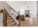 Spacious living room with stone fireplace, stairs and hardwood floors at 356 Avery Glenn Way, Fuquay Varina, NC 27526