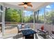 Relaxing screened porch features comfortable seating, a ceiling fan, and views of the lush backyard at 356 Avery Glenn Way, Fuquay Varina, NC 27526
