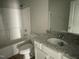 Bright bathroom featuring a tub and shower combination with a granite topped vanity sink at 37 Heatherglenn Cir, Princeton, NC 27569