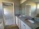 Bathroom with dual vanity sinks, granite countertop, and a large mirror at 37 Heatherglenn Cir, Princeton, NC 27569