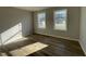 Bright bedroom featuring luxury vinyl flooring and two windows for natural light at 37 Heatherglenn Cir, Princeton, NC 27569