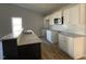 Modern kitchen featuring white cabinets, granite countertops, and stainless steel appliances at 37 Heatherglenn Cir, Princeton, NC 27569