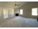 Spacious living room featuring plush carpet flooring, fireplace, and plenty of natural light at 37 Heatherglenn Cir, Princeton, NC 27569