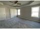 Comfortable main bedroom featuring plush carpet flooring, ceiling fan, and tray ceiling at 37 Heatherglenn Cir, Princeton, NC 27569