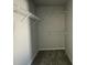 Empty walk-in closet with hanging shelves, ready to be organized with your personal belongings at 37 Heatherglenn Cir, Princeton, NC 27569