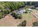 Aerial view of an estate home with lush surroundings, pool, barn, and fenced paddock at 3787 Pleasant Hill Church, Siler City, NC 27344