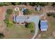 Wide aerial view of estate with pool, patio, circular driveway, and multiple outbuildings at 3787 Pleasant Hill Church, Siler City, NC 27344