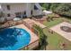 Aerial view of backyard with wooden deck, in-ground pool with cover, lush landscaping, and pergola at 3787 Pleasant Hill Church, Siler City, NC 27344