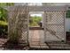 A view of the backyard patio, with pergola, brick path, and wooded view at 3787 Pleasant Hill Church, Siler City, NC 27344