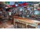 Eclectic bar area with wood counter, stools, and extensive wall decor at 3787 Pleasant Hill Church, Siler City, NC 27344