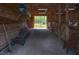 Rustic barn interior with wooden stalls, dirt floor, and natural light at 3787 Pleasant Hill Church, Siler City, NC 27344