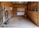 Empty barn stall with wood paneling, concrete floor, and functional features at 3787 Pleasant Hill Church, Siler City, NC 27344
