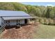 Barn featuring a metal roof, sliding doors, and a wooden fence to the left at 3787 Pleasant Hill Church, Siler City, NC 27344