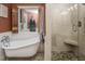 Well-lit bathroom with clawfoot tub and glass shower, exuding relaxation and luxury at 3787 Pleasant Hill Church, Siler City, NC 27344
