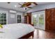 Vaulted ceiling bedroom with white bedding, barn door, and windows letting in light at 3787 Pleasant Hill Church, Siler City, NC 27344
