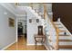 Welcoming foyer with hardwood floors, stairs to the second floor, and an open view of the living room with fireplace at 3787 Pleasant Hill Church, Siler City, NC 27344