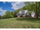 Traditional-style home featuring a covered front porch and ample green space in a serene, wooded setting at 3787 Pleasant Hill Church, Siler City, NC 27344