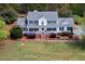 Charming two-story home with a covered front porch, black shutters, and lush landscaping at 3787 Pleasant Hill Church, Siler City, NC 27344