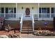 Charming front porch with brick steps, white railing, and decorative accents at 3787 Pleasant Hill Church, Siler City, NC 27344
