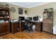 This home office has dark wood furnishings, computer monitors, and is adjacent to built-in shelves at 3787 Pleasant Hill Church, Siler City, NC 27344