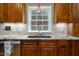 Modern kitchen featuring custom cabinets, granite countertops, stainless steel appliances, and sink with window view at 3787 Pleasant Hill Church, Siler City, NC 27344