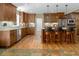 Open kitchen featuring custom wood cabinets, stainless appliances, granite counters, and an island with seating at 3787 Pleasant Hill Church, Siler City, NC 27344