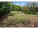View of land featuring a wire fence and a lush field of grass surrounded by trees at 3787 Pleasant Hill Church, Siler City, NC 27344