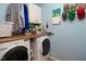 Functional laundry room with a washer and dryer, overhead cabinets, and a wood countertop for folding and organization at 3787 Pleasant Hill Church, Siler City, NC 27344