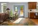 Cozy living room featuring a tiled floor, doors to the deck, a sofa, and a small kitchen area with tile backsplash at 3787 Pleasant Hill Church, Siler City, NC 27344