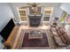 Open living room with tall windows, a leather sofa, and fireplace offering a cozy and inviting atmosphere at 3787 Pleasant Hill Church, Siler City, NC 27344