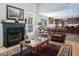 Inviting living room featuring a fireplace, hardwood floors, ample natural light, and an open view to the kitchen at 3787 Pleasant Hill Church, Siler City, NC 27344