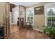 Cozy living area featuring hardwood floors, sunlit windows, and glass-paned door leading to other parts of the house at 3787 Pleasant Hill Church, Siler City, NC 27344