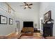 Bright living room featuring hardwood floors, a fireplace, a ceiling fan, and a view of the upstairs landing at 3787 Pleasant Hill Church, Siler City, NC 27344