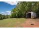 Shed featuring an open front and situated on a plot of grass with a view of trees at 3787 Pleasant Hill Church, Siler City, NC 27344
