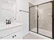 Bright bathroom featuring a glass-enclosed shower with tile and a white vanity with dark fixtures at 40 Rosewood Ln, Youngsville, NC 27596