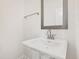 Bright bathroom featuring a single white pedestal sink and mirror at 40 Rosewood Ln, Youngsville, NC 27596