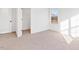Bedroom with neutral carpet, white walls, a large window, and a door leading to a walk-in closet at 40 Rosewood Ln, Youngsville, NC 27596