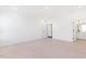 Spacious bedroom with neutral carpet, white walls, and a door leading to an ensuite bathroom at 40 Rosewood Ln, Youngsville, NC 27596