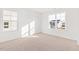 Bright bedroom with neutral carpet, white walls, and two large windows letting in plenty of natural light at 40 Rosewood Ln, Youngsville, NC 27596