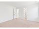 Bedroom with neutral carpet, white walls, and multiple doorways to other areas of the home at 40 Rosewood Ln, Youngsville, NC 27596