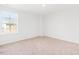 Bedroom with neutral carpet, white walls, and a window providing natural light at 40 Rosewood Ln, Youngsville, NC 27596