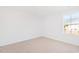 Bedroom featuring neutral carpet, white walls, and a window with a view of the outdoors at 40 Rosewood Ln, Youngsville, NC 27596