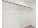 Walk-in closet features a wooden hanging rod at 40 Rosewood Ln, Youngsville, NC 27596